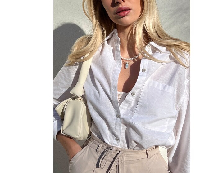 model in camasa alba de in si geanta de mana de culoare deschisa