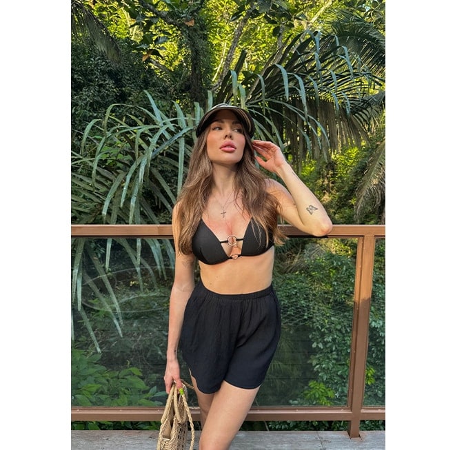 influencerka w stroju kąpielowych i luźnych szortach